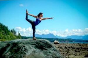 In the image, a young and beautiful girl is shown doing yoga.
